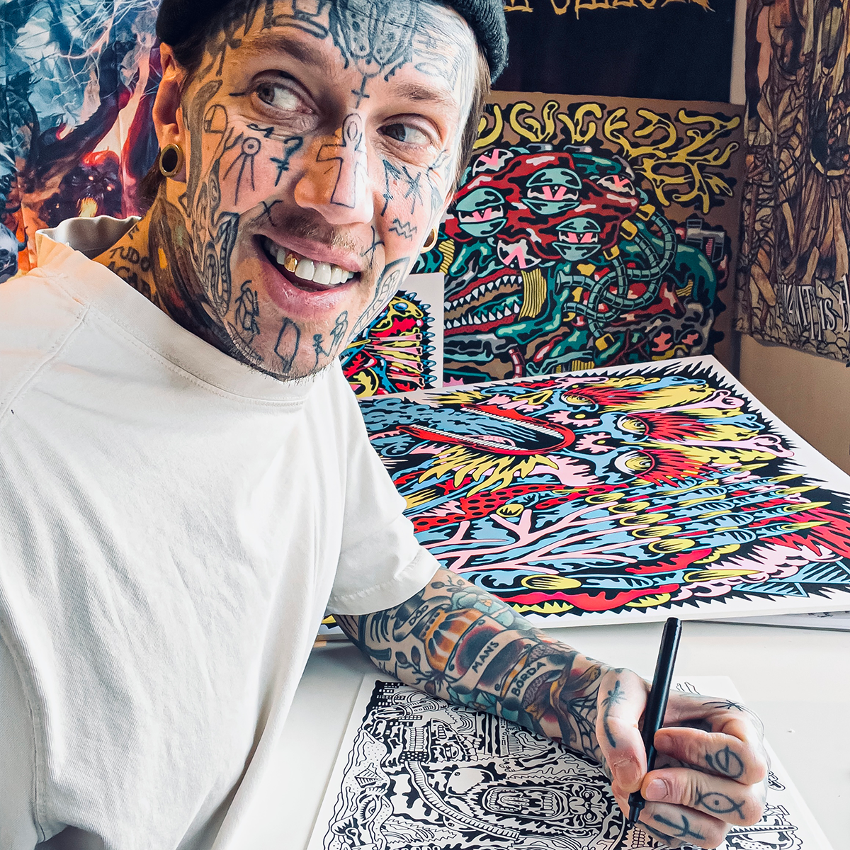 Marc UA drawing intricate designs, with colorful artwork displayed in the background.