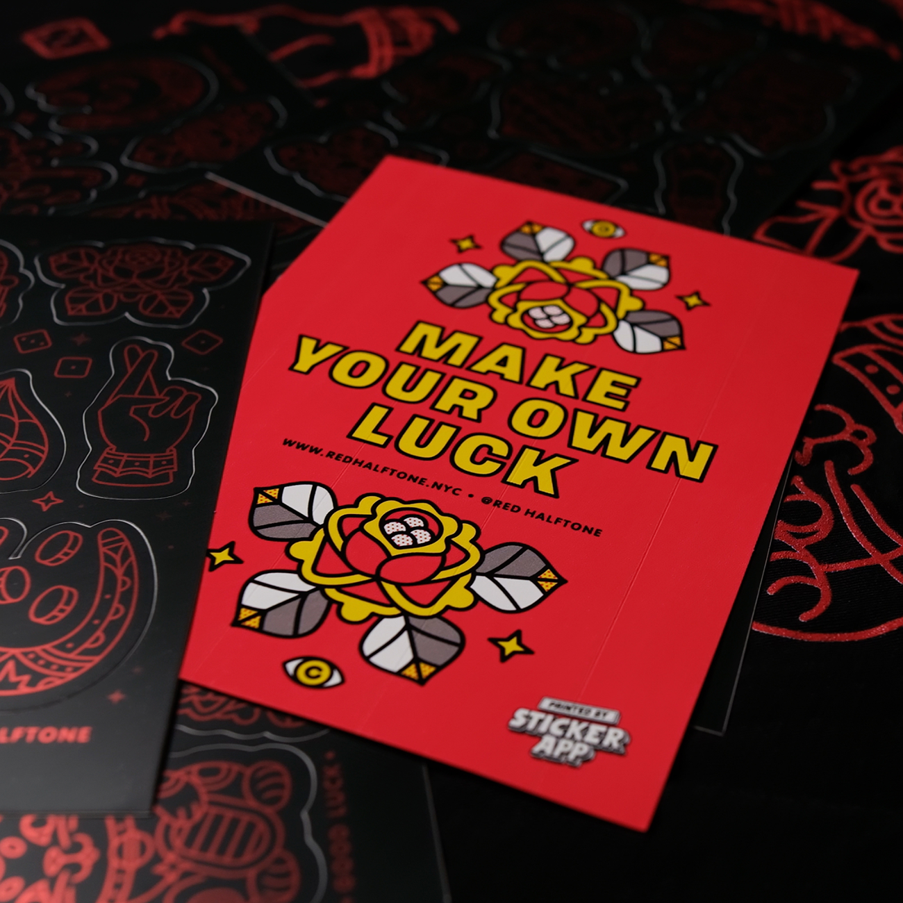 Custom sticker sheet with back paper print with the text "MAKE YOUR OWN LUCK" on a bed of sticker sheets.