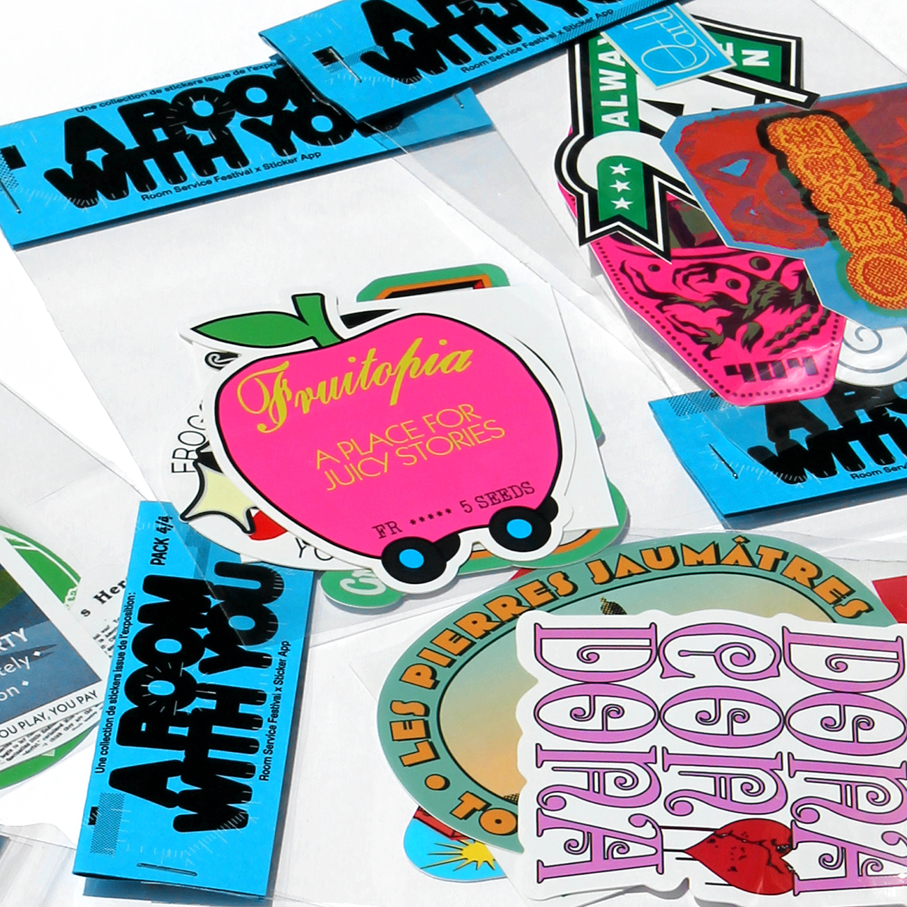 colorful sticker packs with an apple and motel sign, with the header text "A ROOM WITH YOU", against a white background