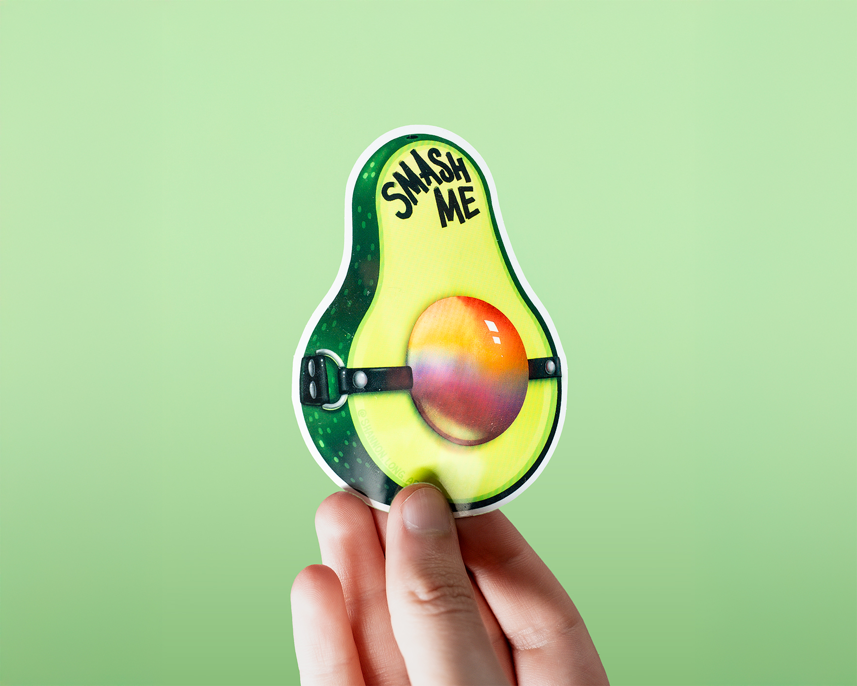Avocado with a gag ball with the text "smash me"