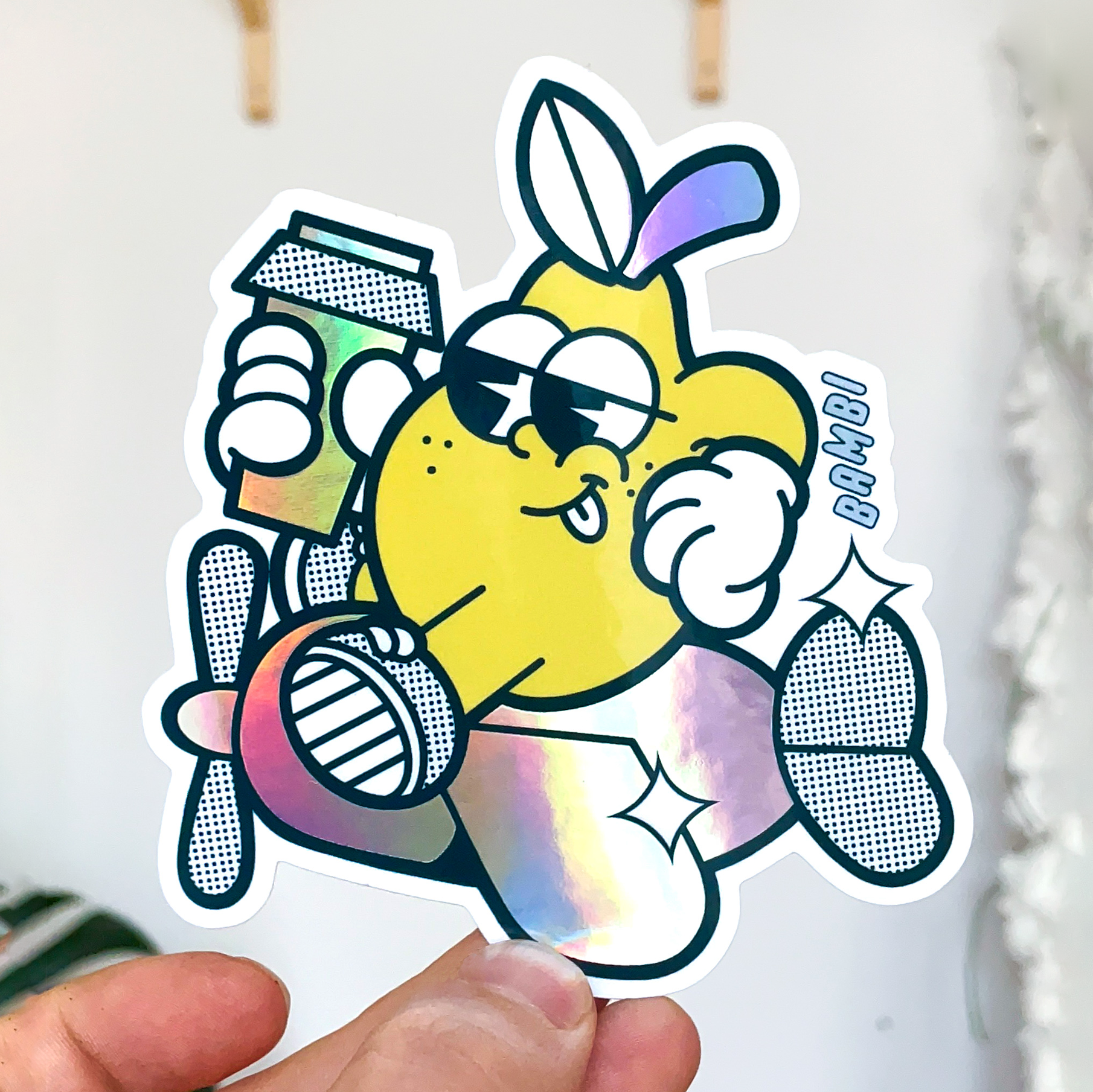 Cartoon holographic die cut sticker of a yellow character on an airplane, holding a coffee and smiling.