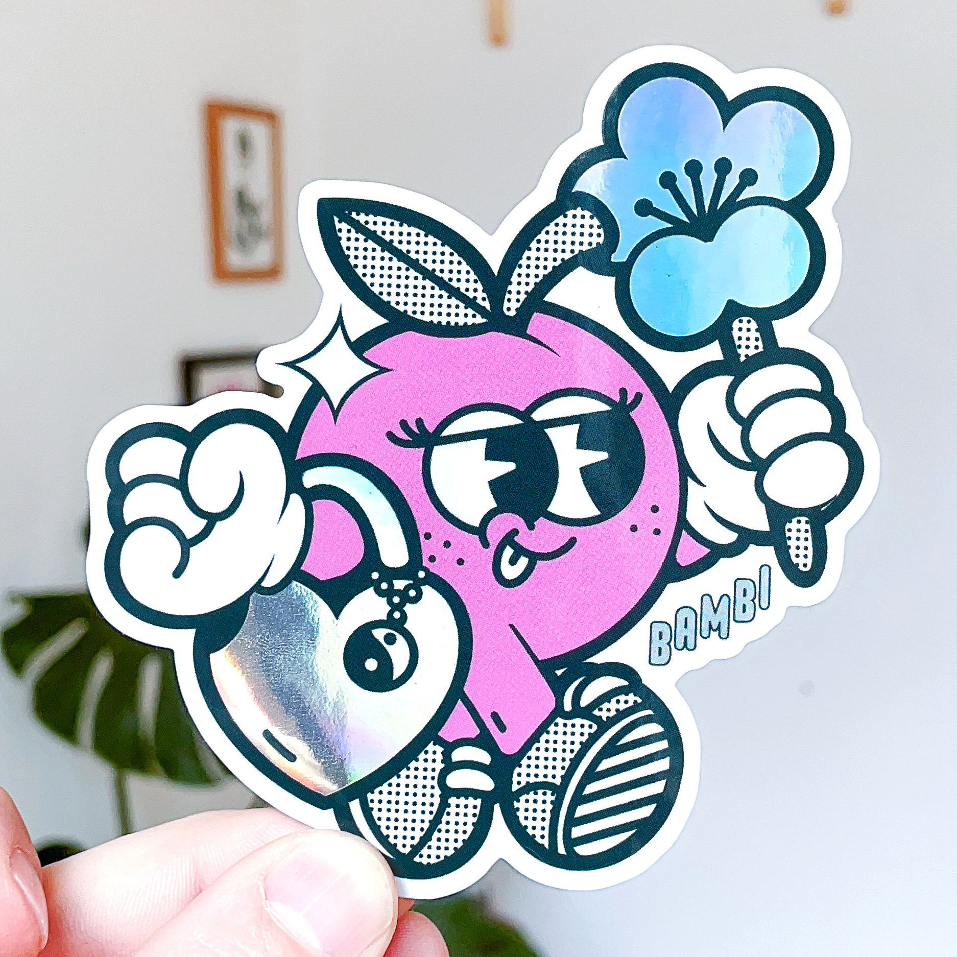 Holographic die cut sticker of a cartoon pink character holding a blue flower and shiny heart.