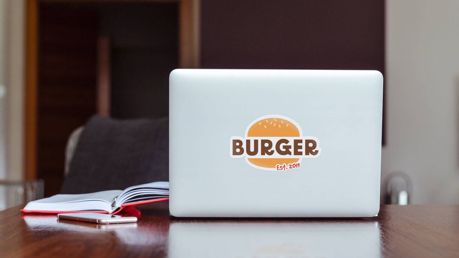 Burger logo sticker on a laptop.