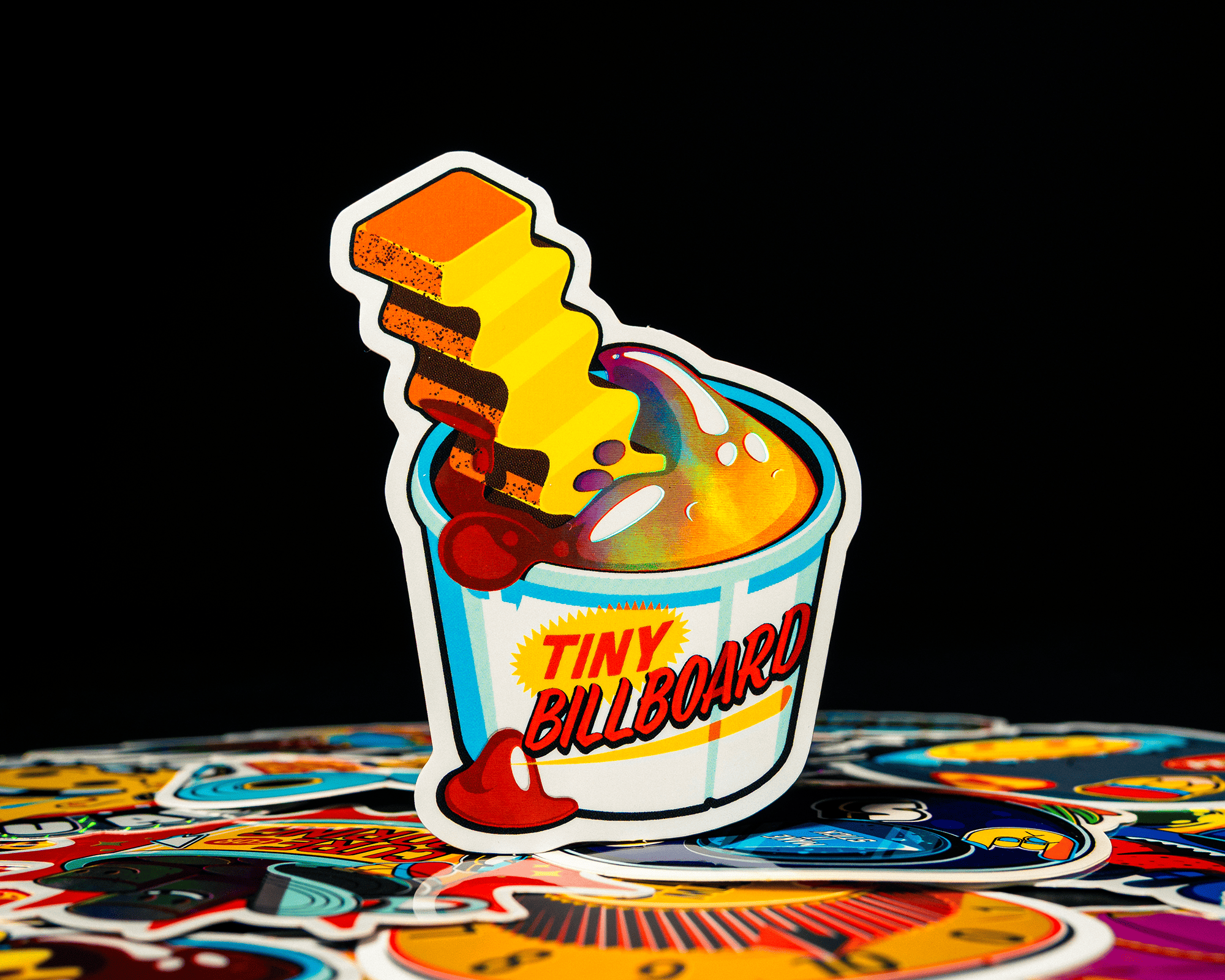 A colorful sticker of a french fry dipped in ketchup