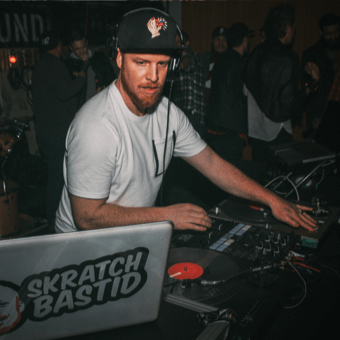 DJ with a sticker slaped laptop.