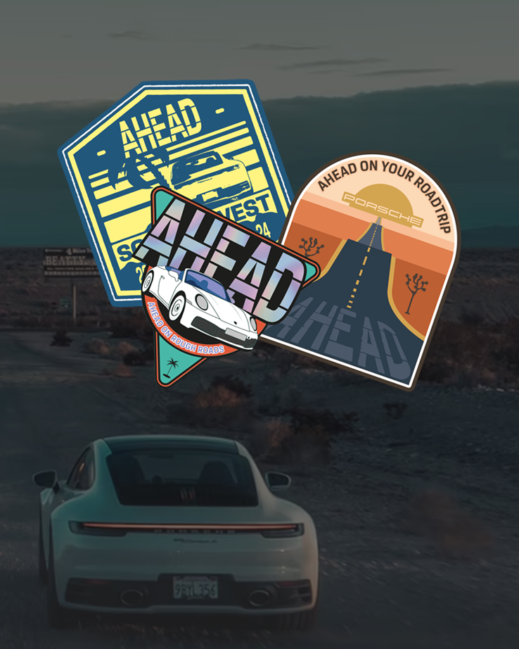 Three colorful car-themed stickers overlaid on a background of a porsche driving on a desert road.