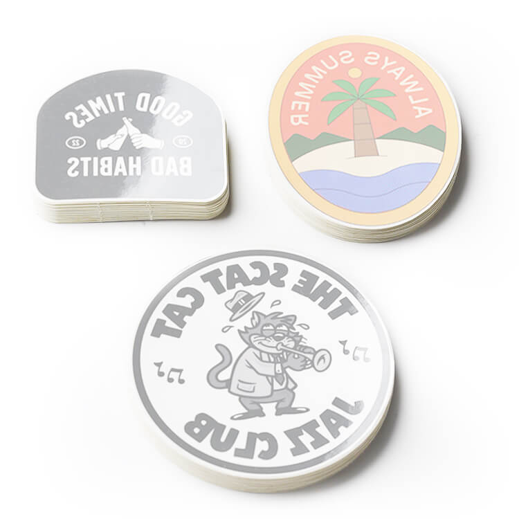 Three front adhesive stickers of the cat club on a white surface.