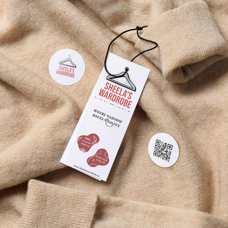 Hang tag stickers attached to clothes is laying on a bed.